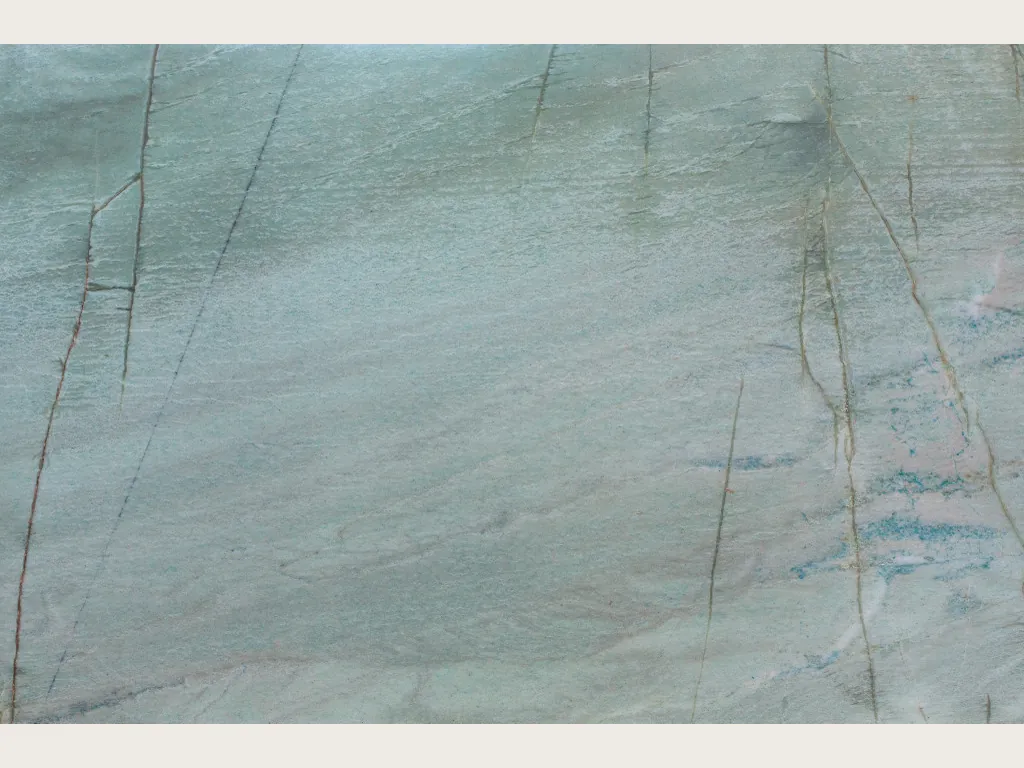 Slab of Emerald Green quartzite: pale sea green background with fine, nearly vertical dark lines