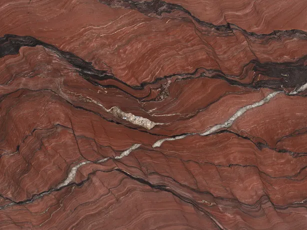 Detail of Fusion Red quartzite: dark brown waves and a white vein with a polished sheen