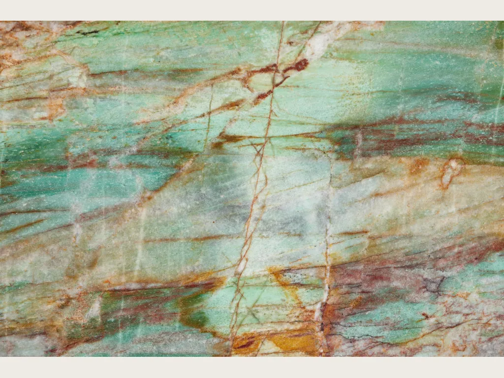 Green Luise quartzite slab: turquoise sea green background with a grid of rust red and ochre veins
