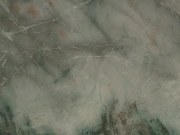Close-up of green Jadore quartzite: sage green clouds and light veins over the polish