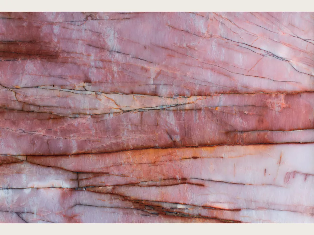 Pink Juliet quartzite slab: pink and white background with horizontal rust red and orange veins