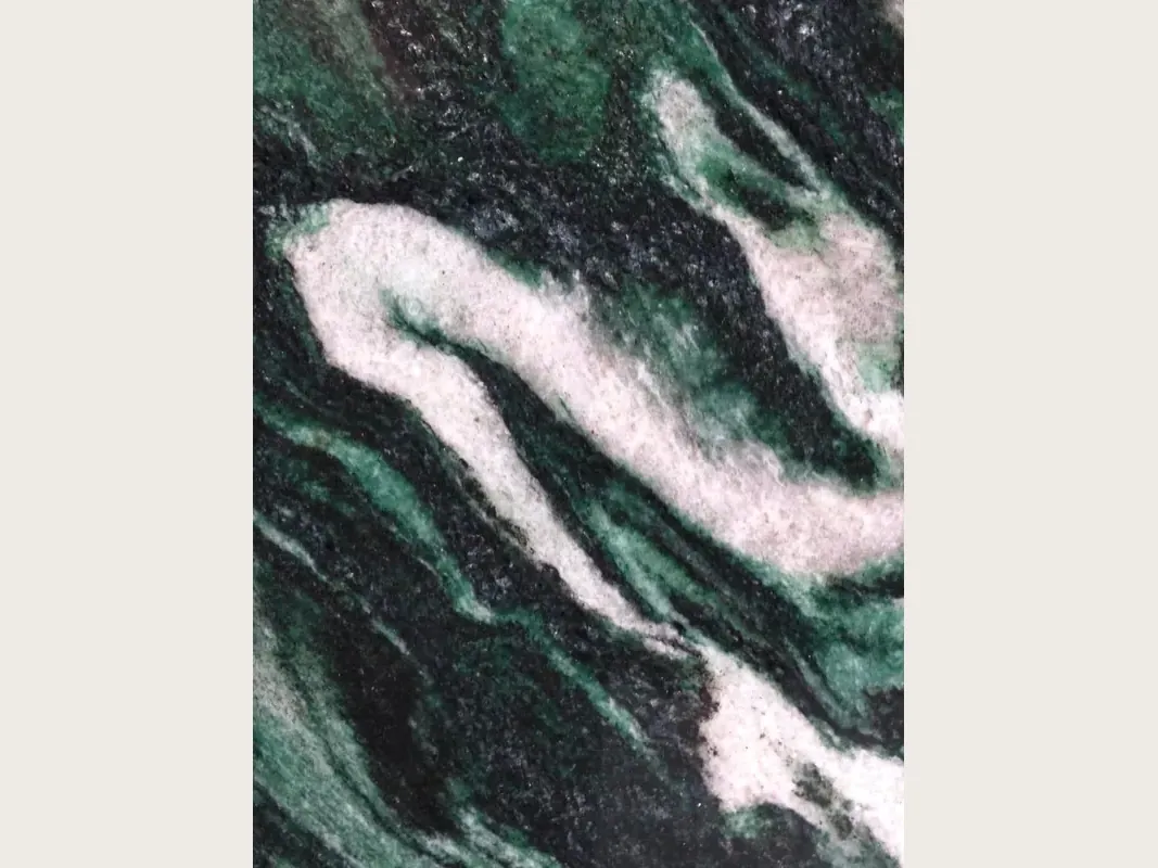 Lapponia Green quartzite slab: dark emerald green and black background with large pinkish white waves on the diagonal