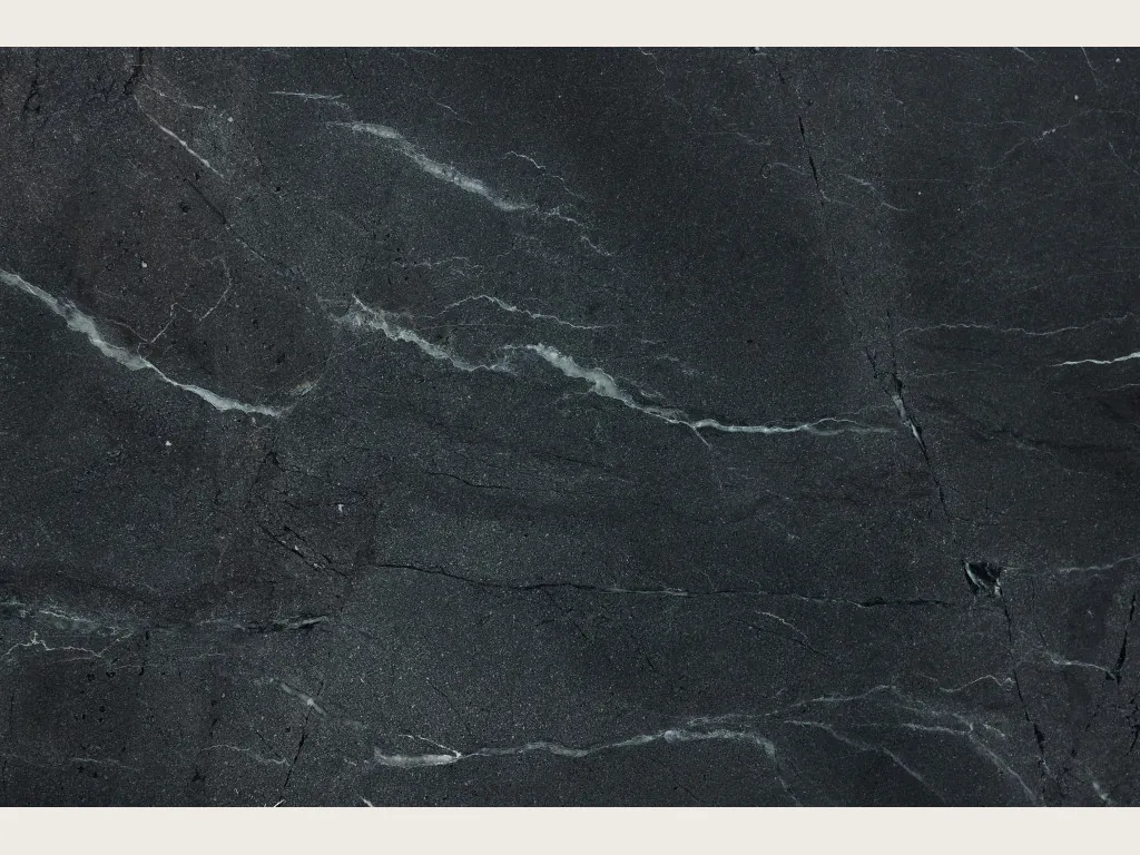 Negresco black quartzite slab: grayish black background with fine diagonal white veins