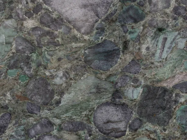 Detail of the Palladium Green slab: rounded violet-gray clasts and green matrix up close