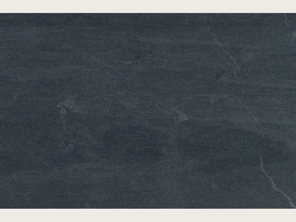 Slab of gray Pietra del Cardoso quartzite: smooth, uniform dark slate gray, no veins