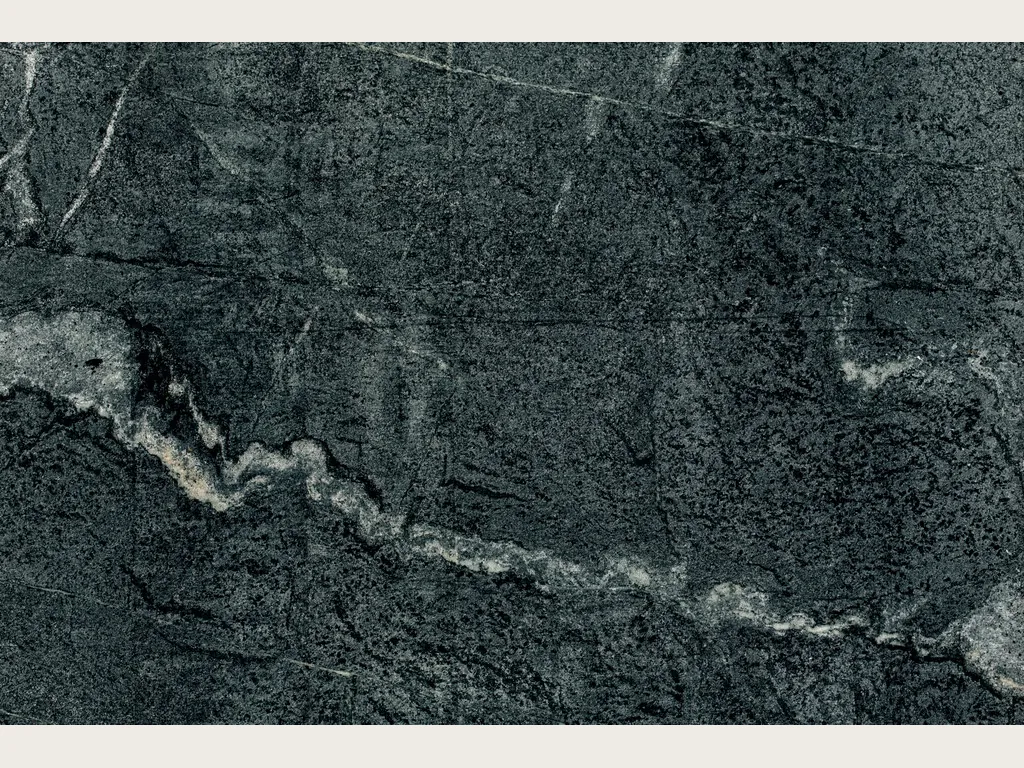 Slab of green Pietra Ollare quartzite: granular near-black green with a white vein waving on the diagonal