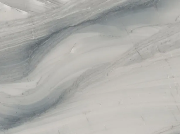 Detail of gray Polaris quartzite: soft blue-gray waves over the light gray