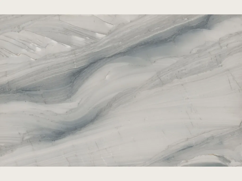 Slab of gray Polaris quartzite: light gray background with wavy blue-gray bands on the diagonal