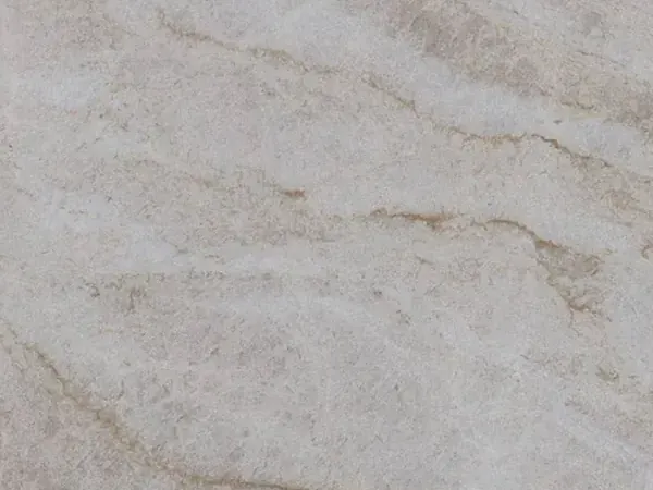 Taj Mahal quartzite slab: light beige background with soft caramel veins in a diagonal
