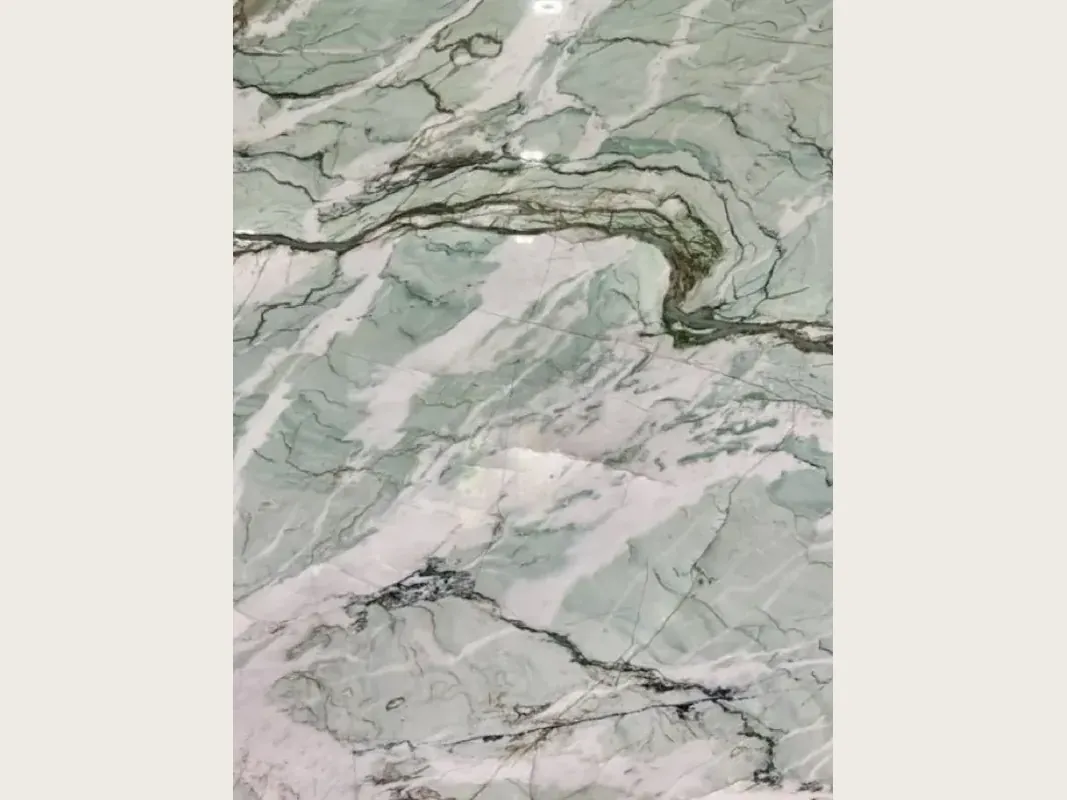 Slab of green Tiffany Wow quartzite: pale aqua background with dark green wavy veins and white diagonal strokes