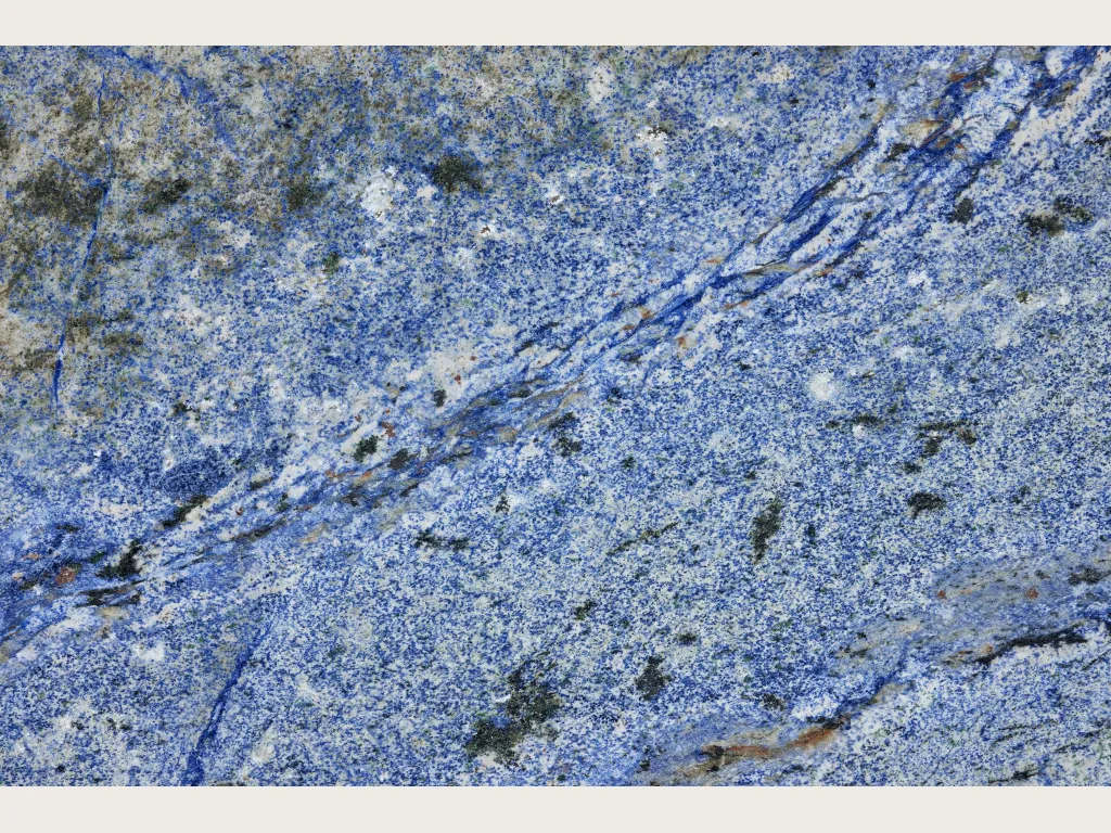 Azul Bahia Granite slab: granular cobalt blue background with white areas and a dark blue diagonal band
