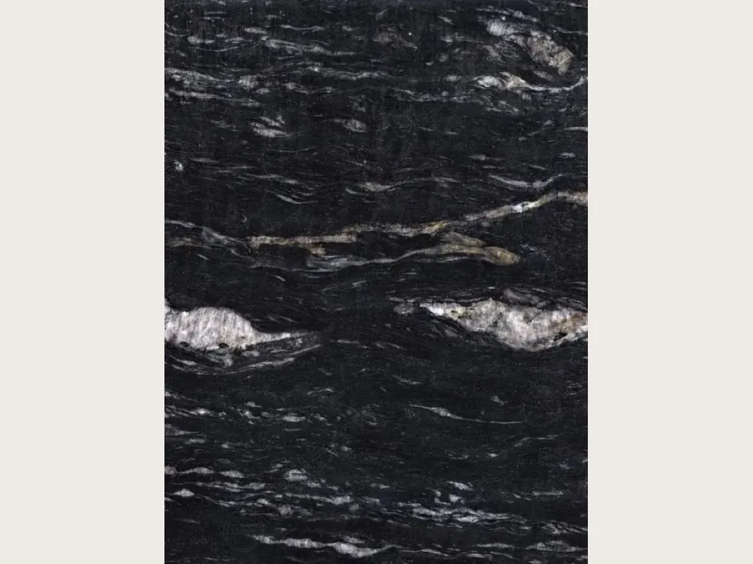 Cosmic Black granite slab: black with wavy white and gray veining and white patches, polished