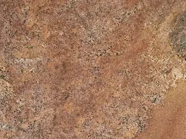 Juparana Florence granite slab: grainy coppery brown with diffuse beige areas, rust touches and a polished shine
