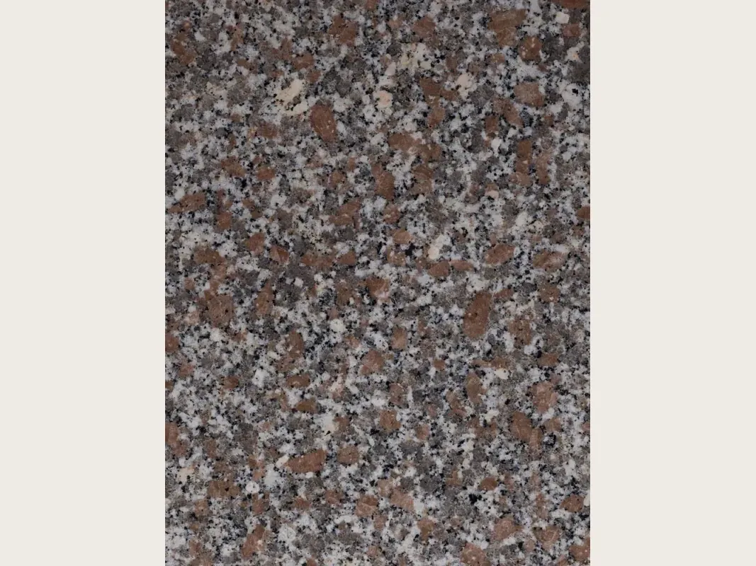 Slab of pink Limbara granite: pinkish-brown grain with white and black crystals