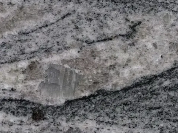 Slab of Piracema White Granite: horizontal wavy bands of gray and white with one large light fragment