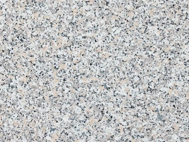 Close-up of Rosa Beta granite: pink and black dots on the polished medium grain
