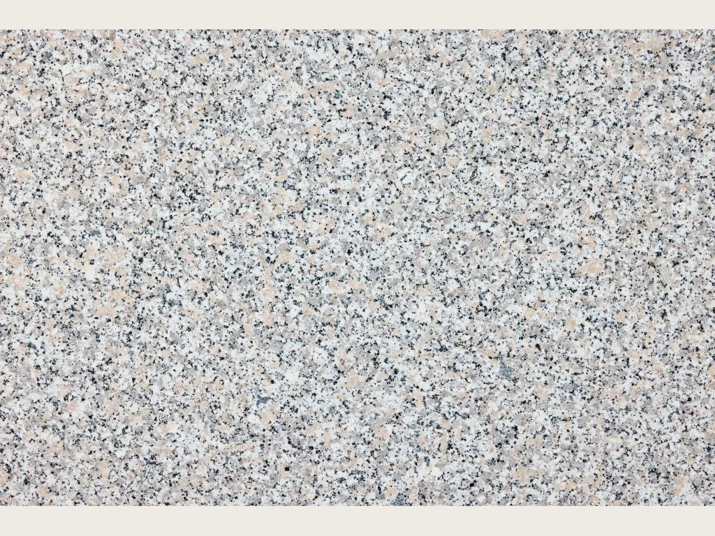 Rosa Beta granite slab: grayish white background with pale pink and black dots spread evenly