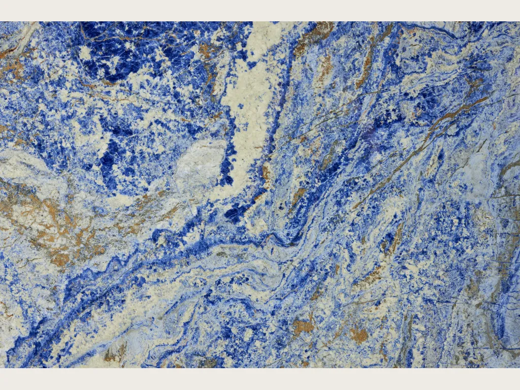 Blue Sodalite granite slab: intense blue with irregular yellowish beige areas and fine white lines (another slab)