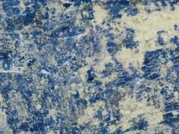 Blue Sodalite granite slab: intense blue with irregular yellowish beige areas and fine white lines