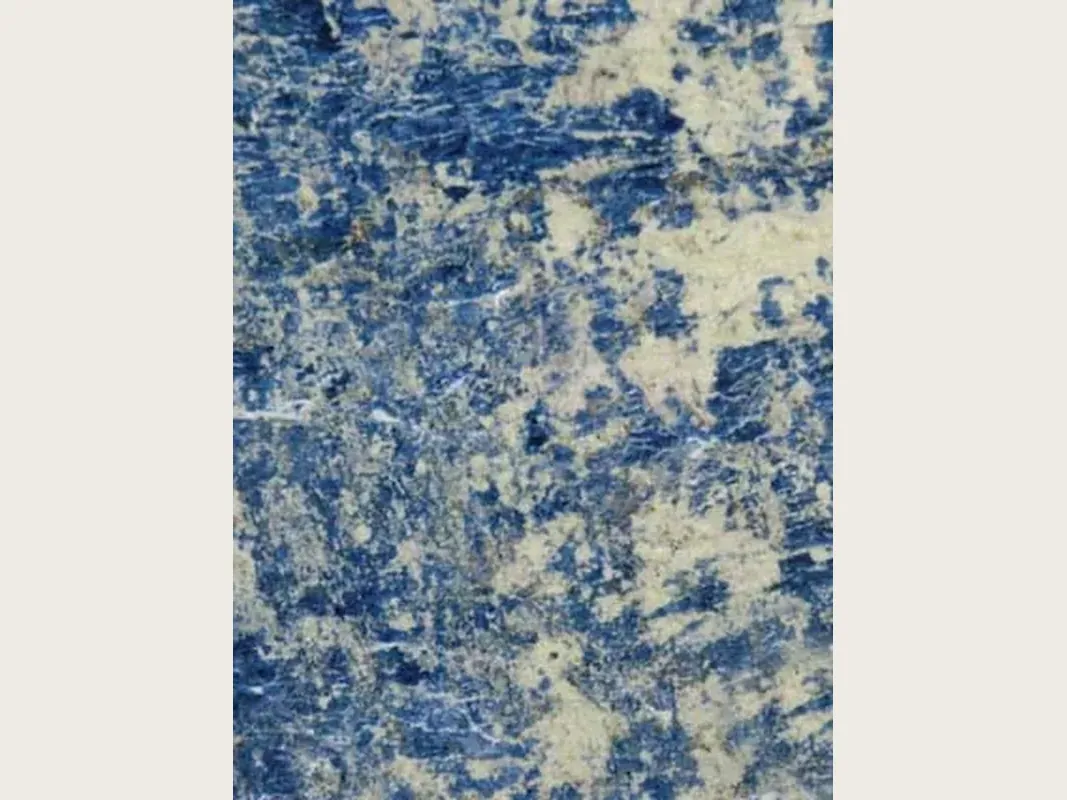 Blue Sodalite granite slab: intense blue with irregular yellowish beige areas and fine white lines