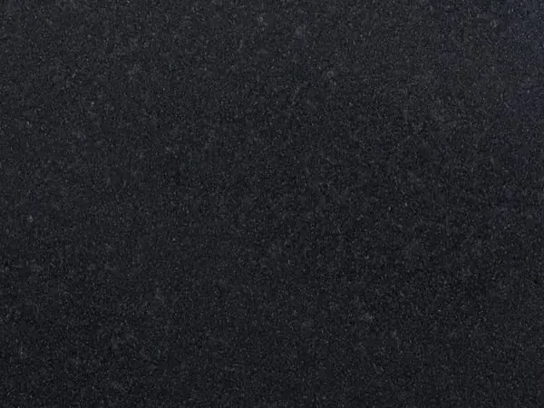 Titanium Black granite slab: deep uniform black, extremely fine barely visible grain and a matte surface