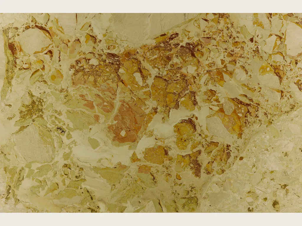 Beige Alma Fuoco marble slab: ocher and rust stains with crisp edges over a greenish cream background