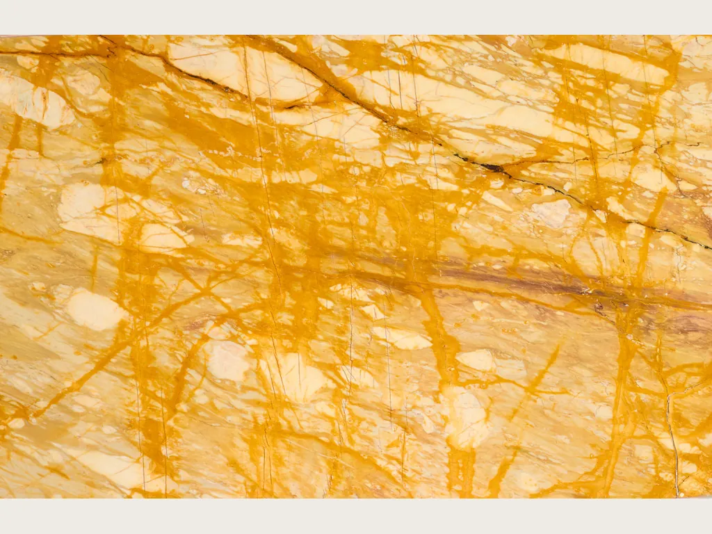 Giallo Siena marble slab: cream background with a dense net of intense yellow veins