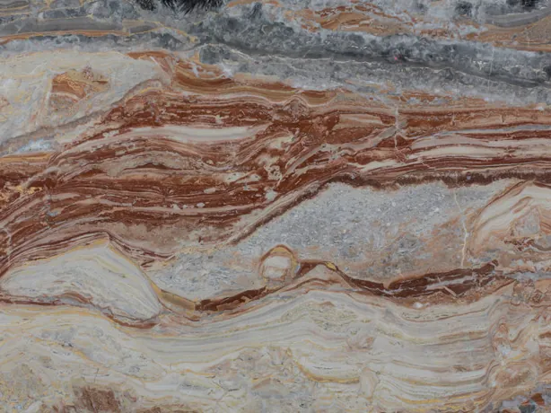 Detail of Arabescato Rosso: wavy bands of brick red, cream and blue gray in a polished finish