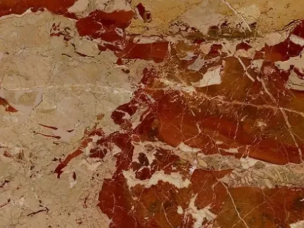 Slab of Arlecchino Marble: large rust-red patches on a pinkish beige background with a network of fine white veins