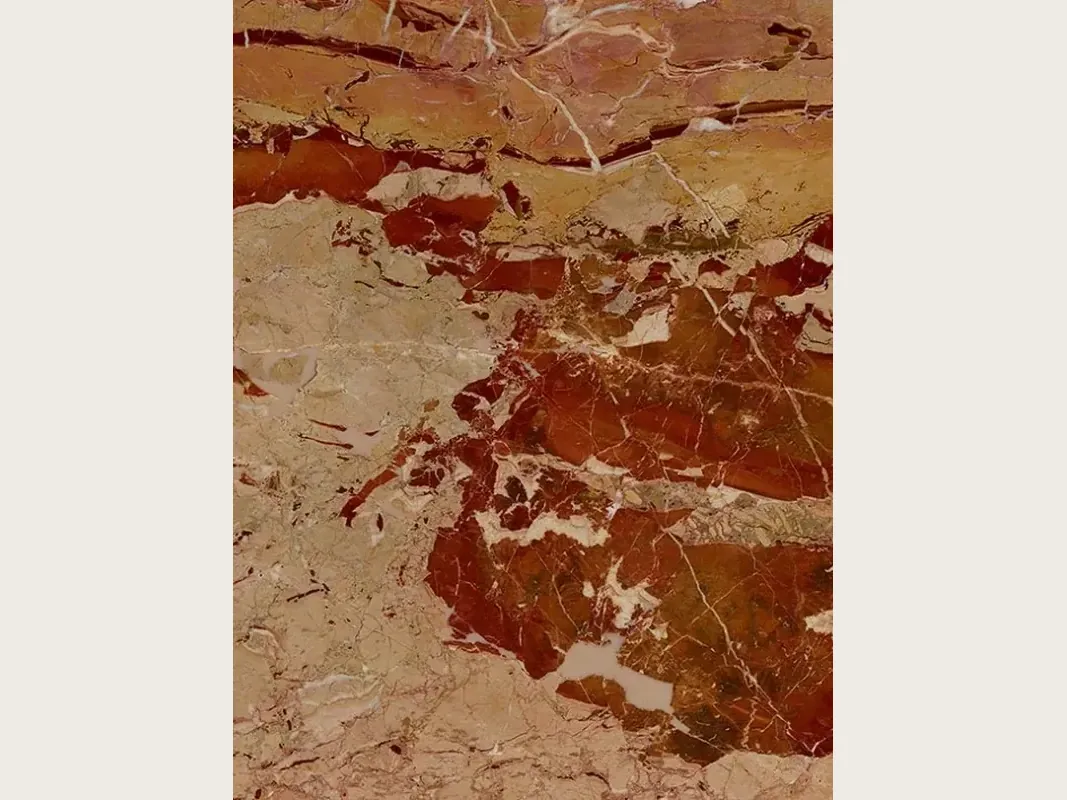 Slab of red Arlecchino marble: large rust-red patches on a pinkish beige background with a network of fine white veins