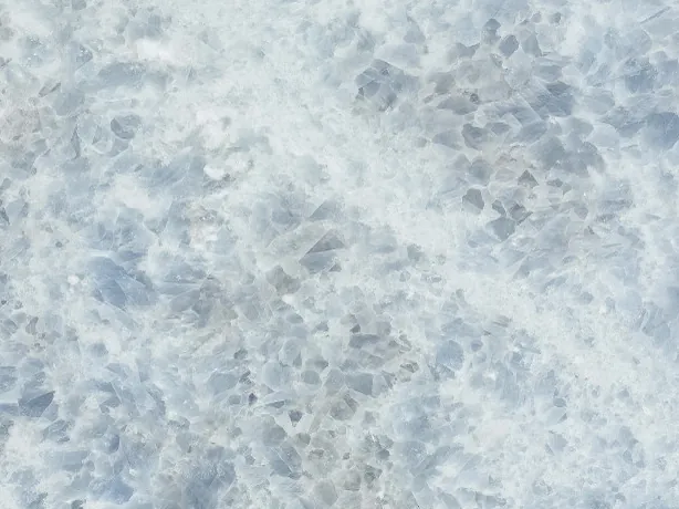 Close-up of the Azul Calcite Marble slab: thick gray-blue crystals on white