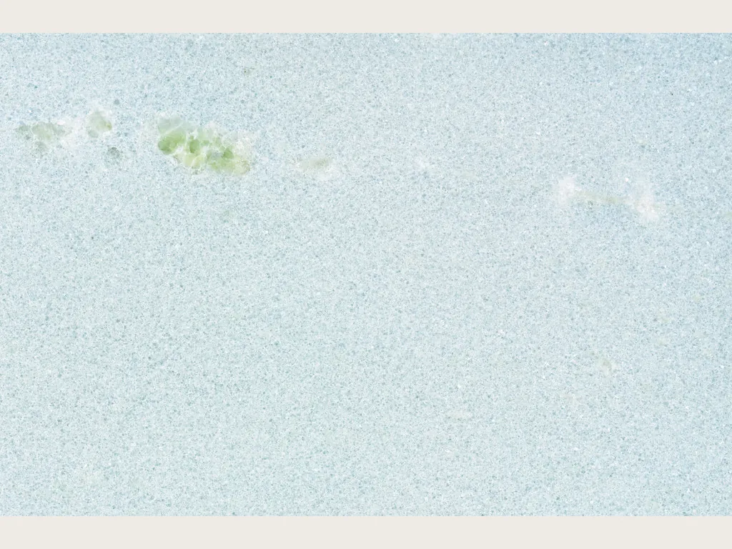 Slab of Azul Cielo marble: uniform pale sky blue, fine grain and a small green inclusion