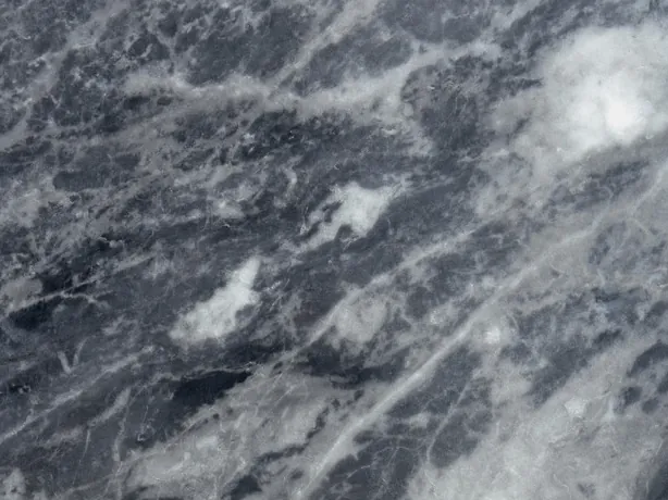 Detail of gray Bardiglio Nuvolato marble: diffuse whitish clouds over the dark gray, with the shine of the polish