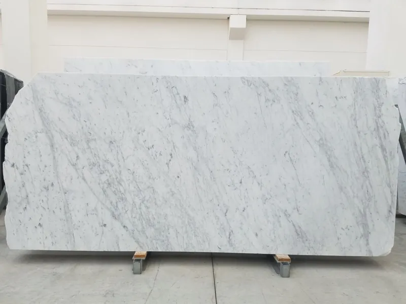 White Bianco Carrara C Extra marble slab: an even white background with fine, soft gray veins on the diagonal