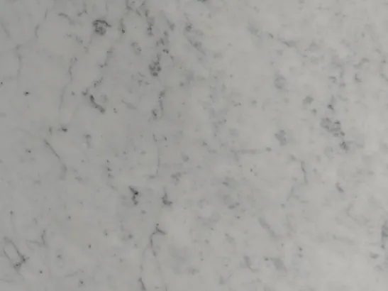Close-up of white Carrara marble: a network of soft gray strokes over the grayish white background