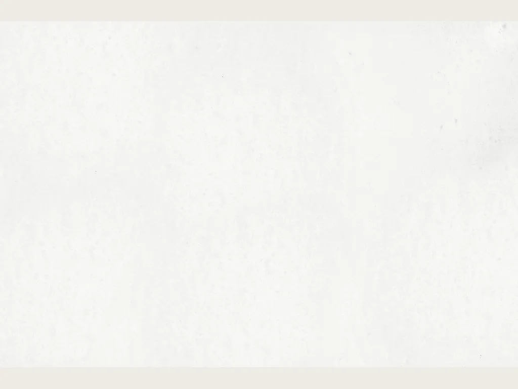 Slab of Bianco Ghiaccio marble: plain pure white, no visible veins, with a soft grayish veil
