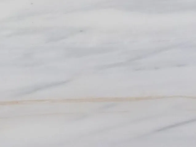 Detail of Bianco Lasa Covelano Gold marble: soft lavender strokes and the fine ochre line over the light background