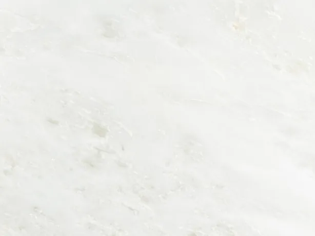 Close-up of Bianco Namibia marble with small specks and very faint clouds