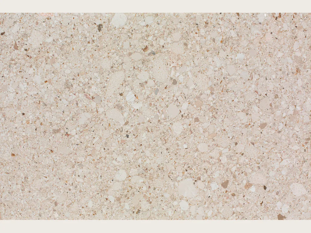 Bianco Romano marble slab: pinkish beige background speckled with light and dark clasts