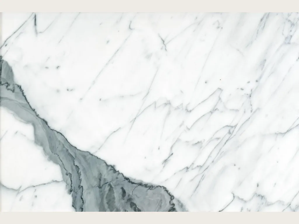 Slab of white Statuario marble: white background with a thick gray-green diagonal vein and fine branching gray veins