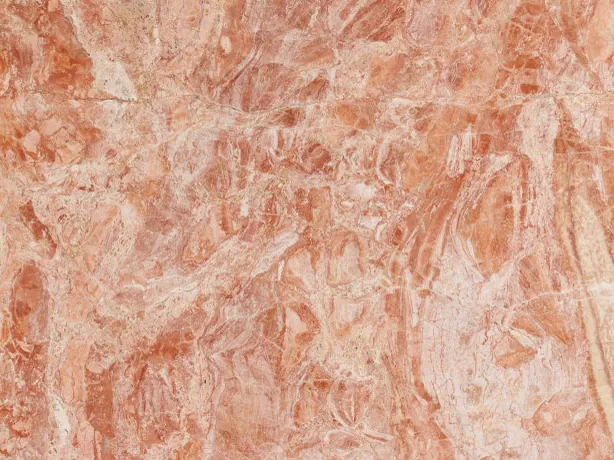 Close-up of the Breccia Bohemien slab: coral and light beige fragments interwoven in salmon tones