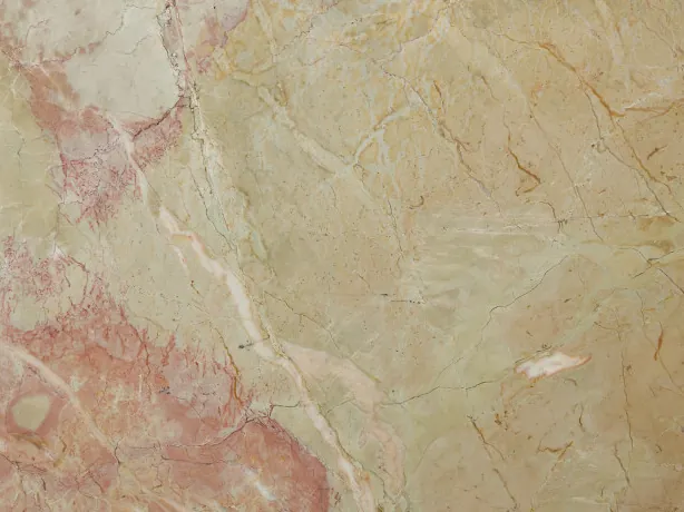 Close-up of beige Breccia D'Aragona marble: fine light veins and coral pink patches over the beige