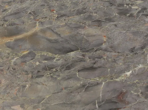 Close-up of gray Breccia di Versailles marble: soft-edged fragments and ochre touches on the high polish