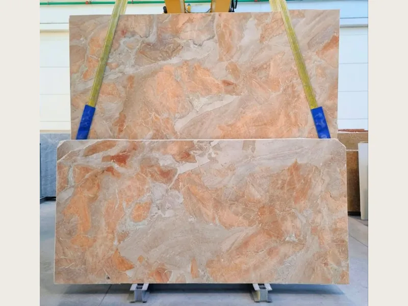 Slab of Breccia Oniciata beige marble: golden beige and cream fragments with concentric waves and a striped brown band (another slab)