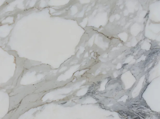 Close-up of white Calacatta marble: the soft gray vein around a white fragment