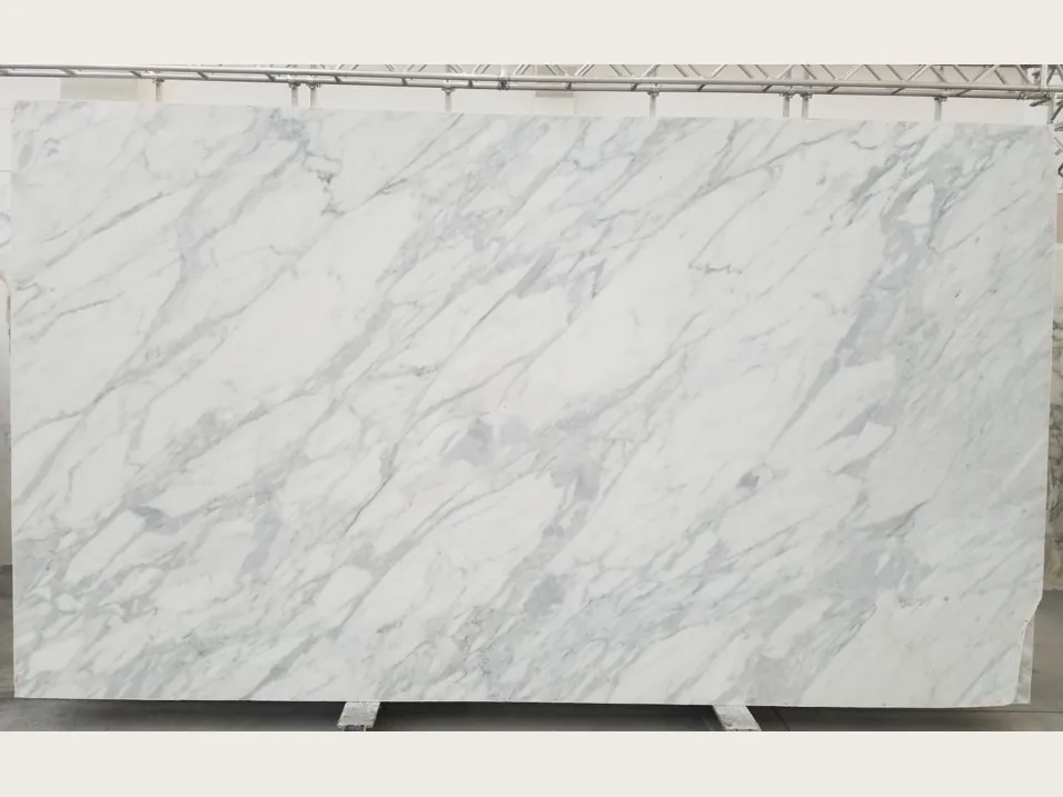 White Calacatta Classic marble slab: white background with fine, diffuse light gray streaks on the diagonal