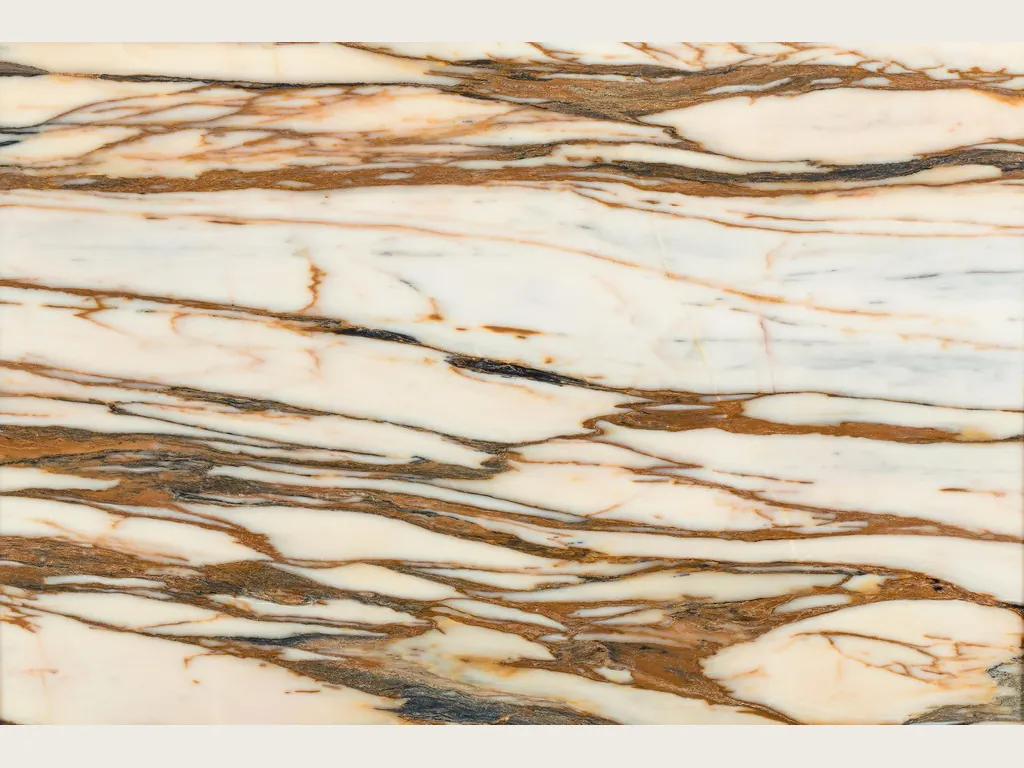 White Calacatta Copper marble slab: cream background with thick copper and brown veins running horizontally