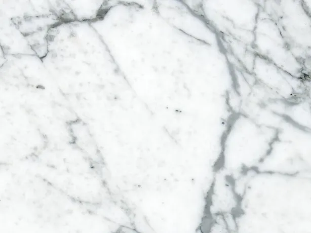 Close-up of white Calacatta Vagli marble: fine gray strokes crossing over the white background