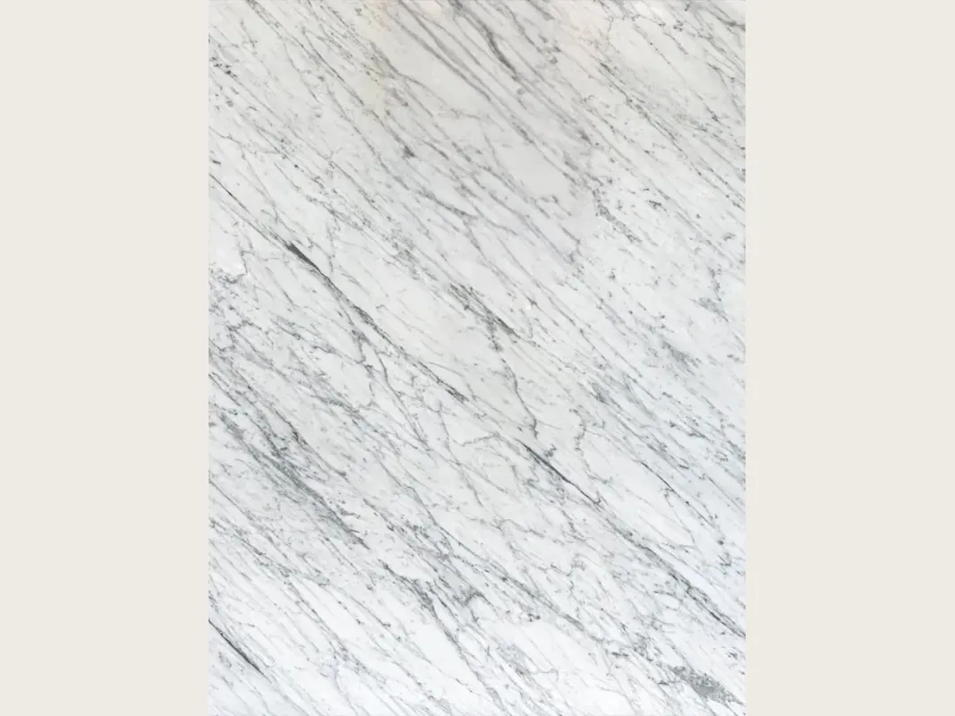 Slab of white Carrara C marble: grayish white background with fine gray veins, parallel and on the diagonal