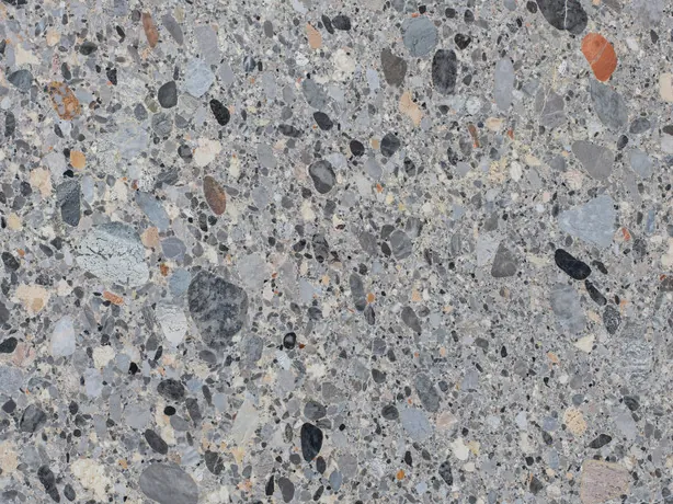 Detail of gray Ceppo marble: pebbles in shades of gray, beige and black in a gray matrix